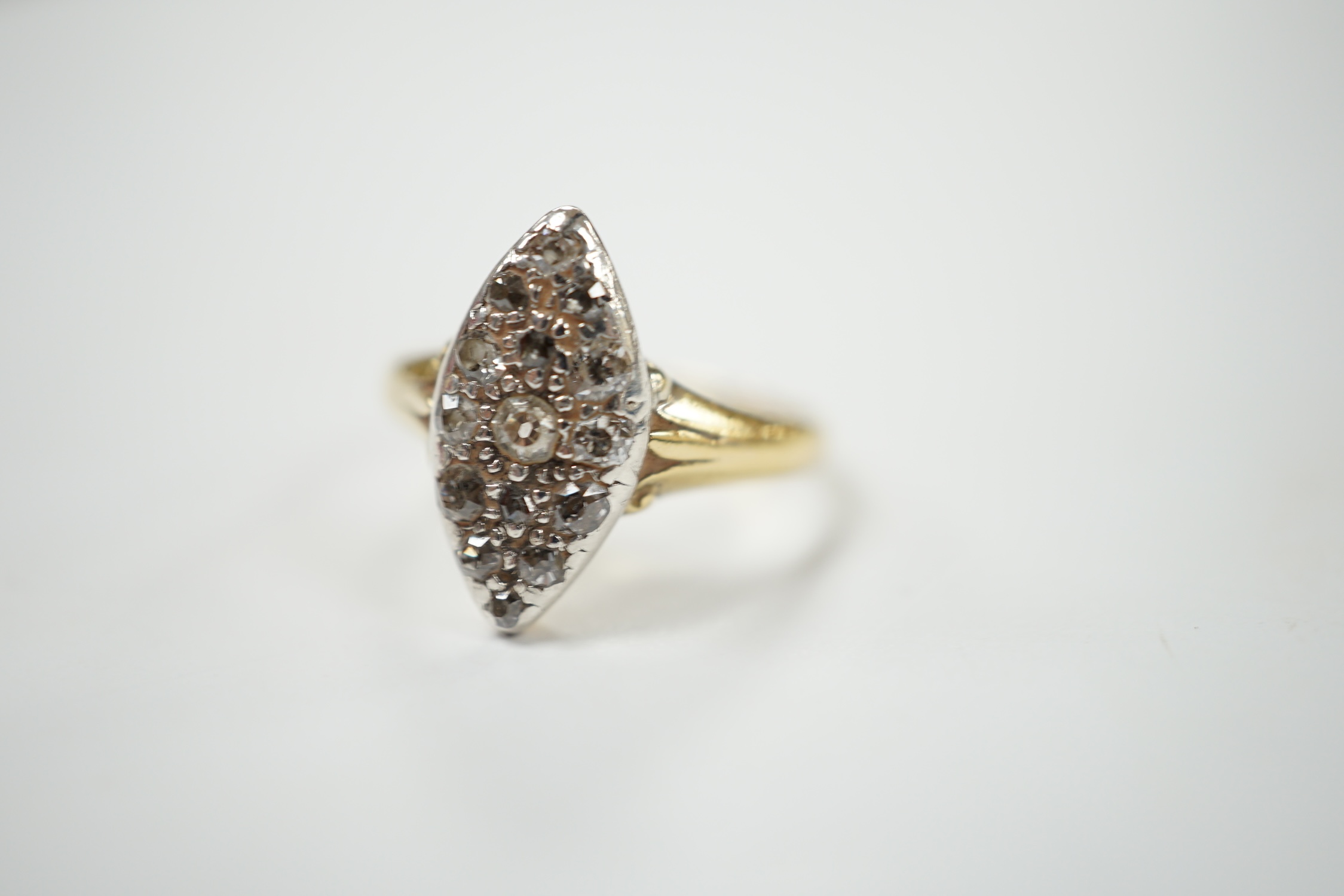 A yellow metal and diamond chip set marquise cluster ring, size K, gross weight 3 grams. Condition - fair
